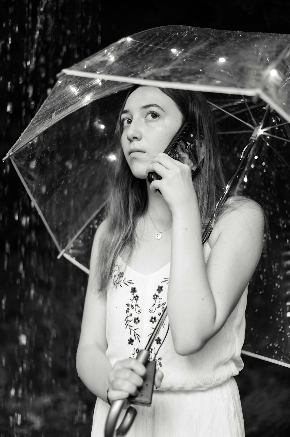 woman in white tank top holding umbrella