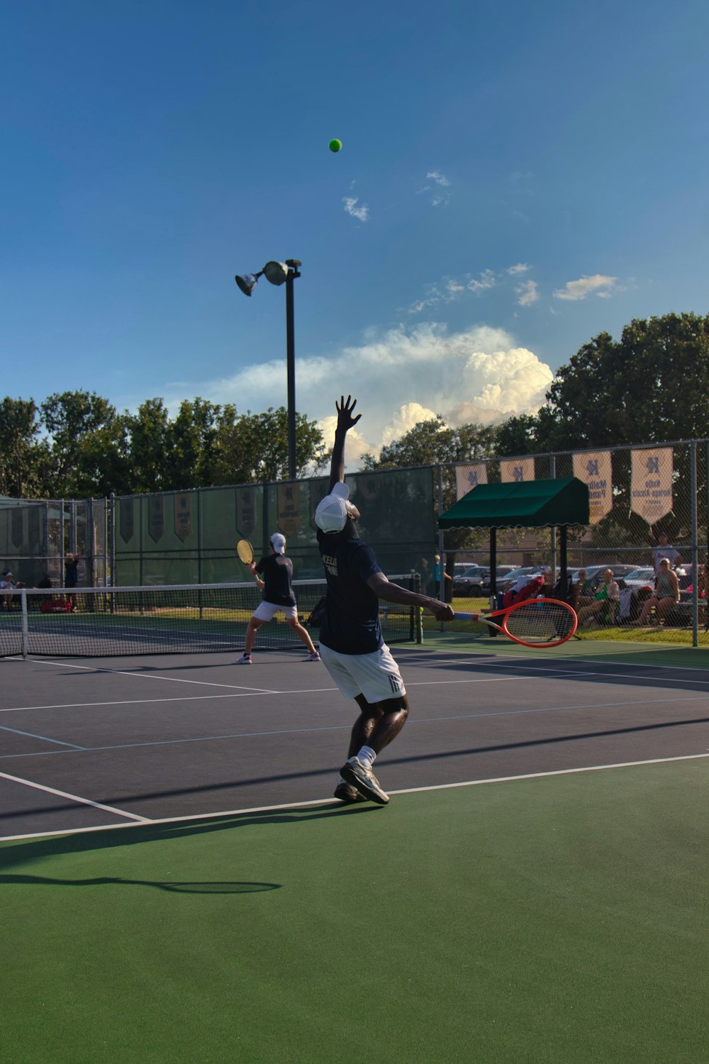 man in black shirt and black shorts playing basketball during daytime