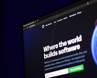 A computer screen displays a website with the text 'Where the world builds software' prominently featured. Below the text, there are fields for users to input their email address, along with additional descriptions about the platform and its capabilities. The website has a dark background with bright text, indicating a professional tech-based service.