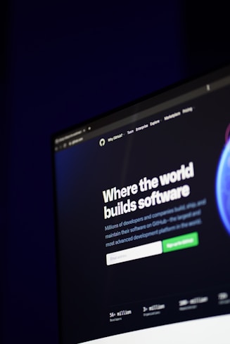 A computer screen displays a website with the text 'Where the world builds software' prominently featured. Below the text, there are fields for users to input their email address, along with additional descriptions about the platform and its capabilities. The website has a dark background with bright text, indicating a professional tech-based service.