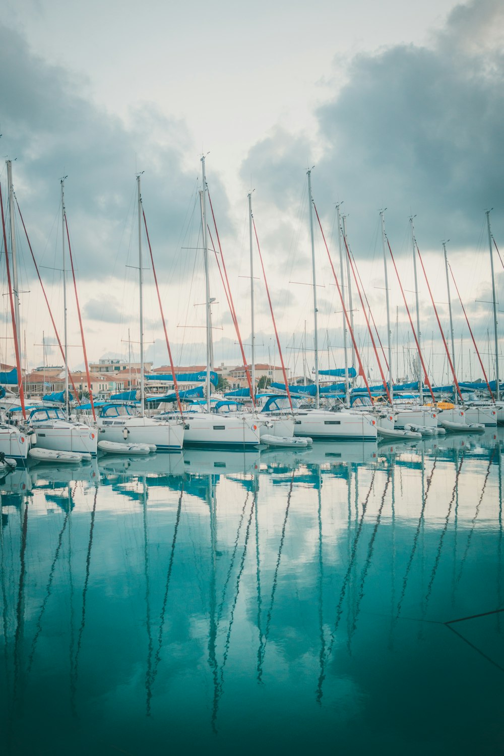 white and blue boats on dock during daytime