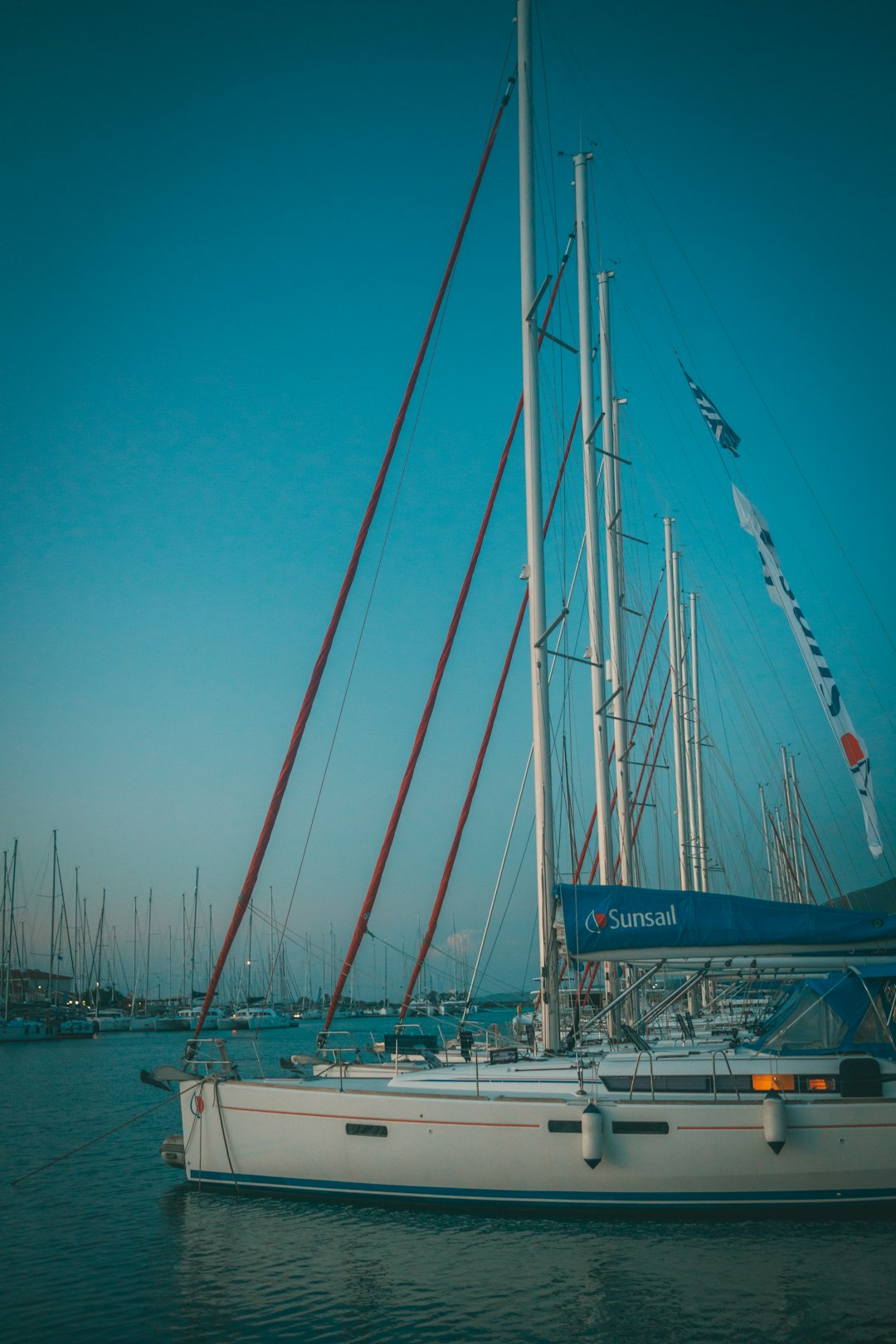 white and blue sail boat on sea during daytime