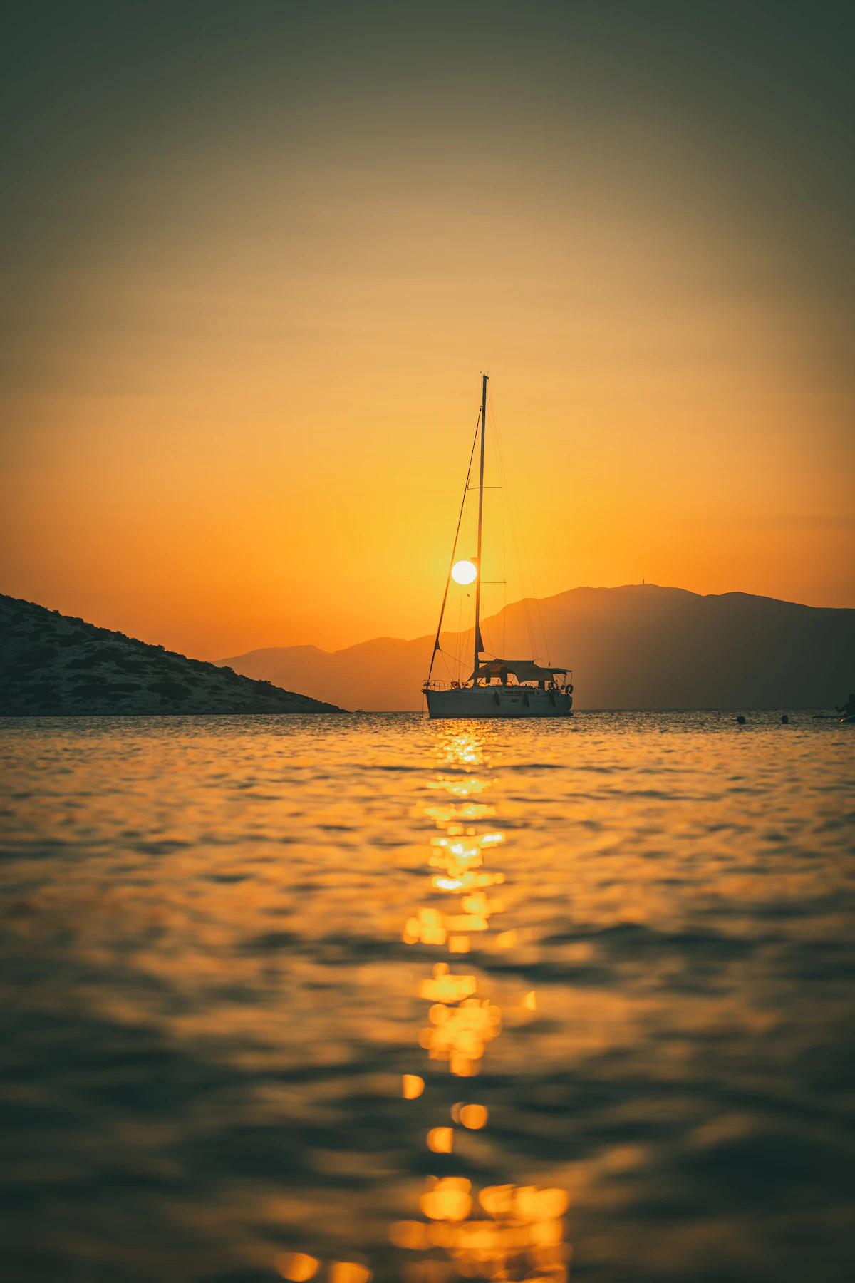 Sailing yacht silhouetted at sunset