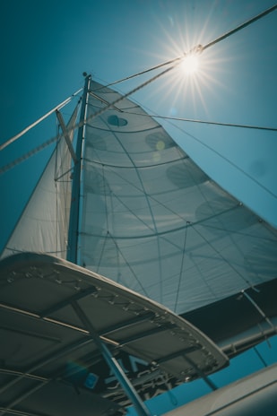 A close-up of a sailboat’s polished deck and rigging shining under the warm sun.