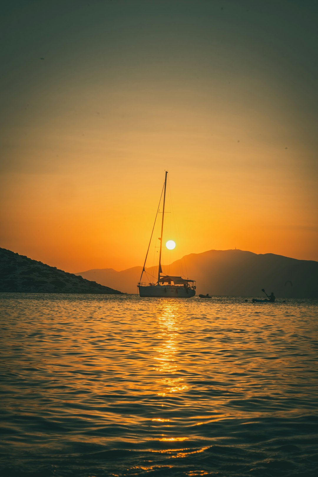 silhouette of boat on sea during sunset