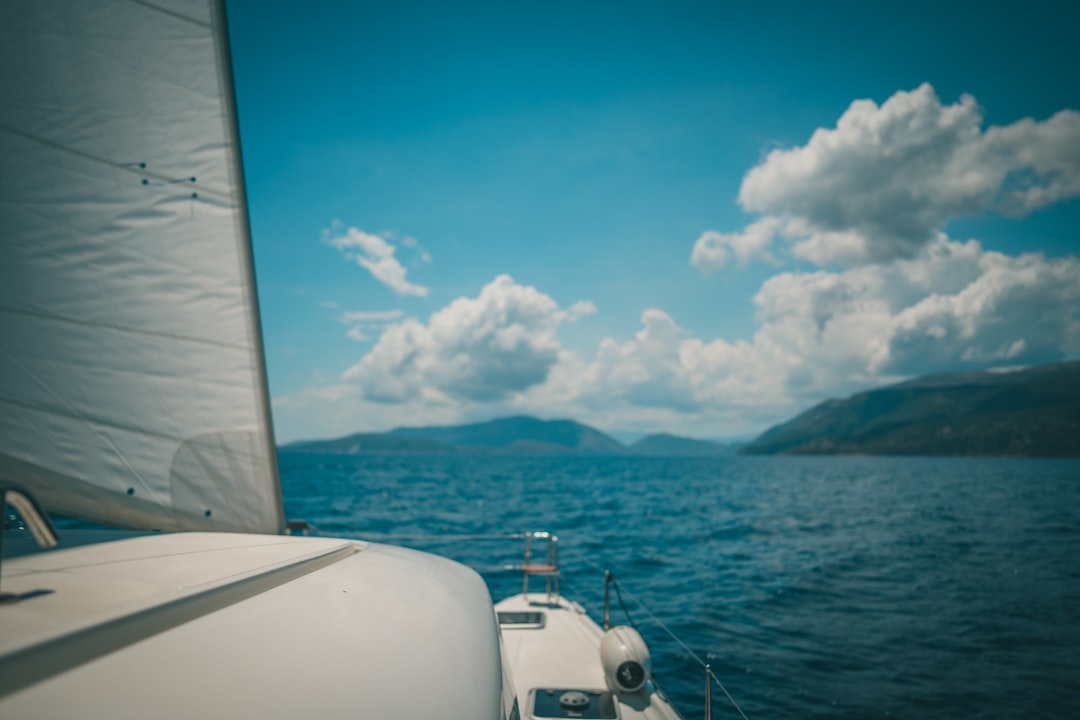 white boat on sea under blue sky during daytime