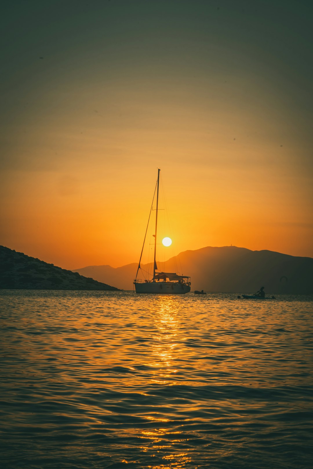 silhouette of boat on sea during sunset