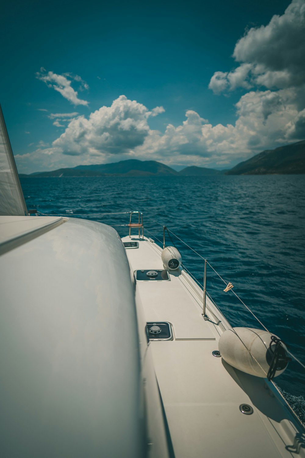 white boat on sea under blue sky during daytime