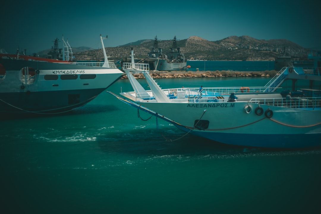 white and blue boat on water during daytime