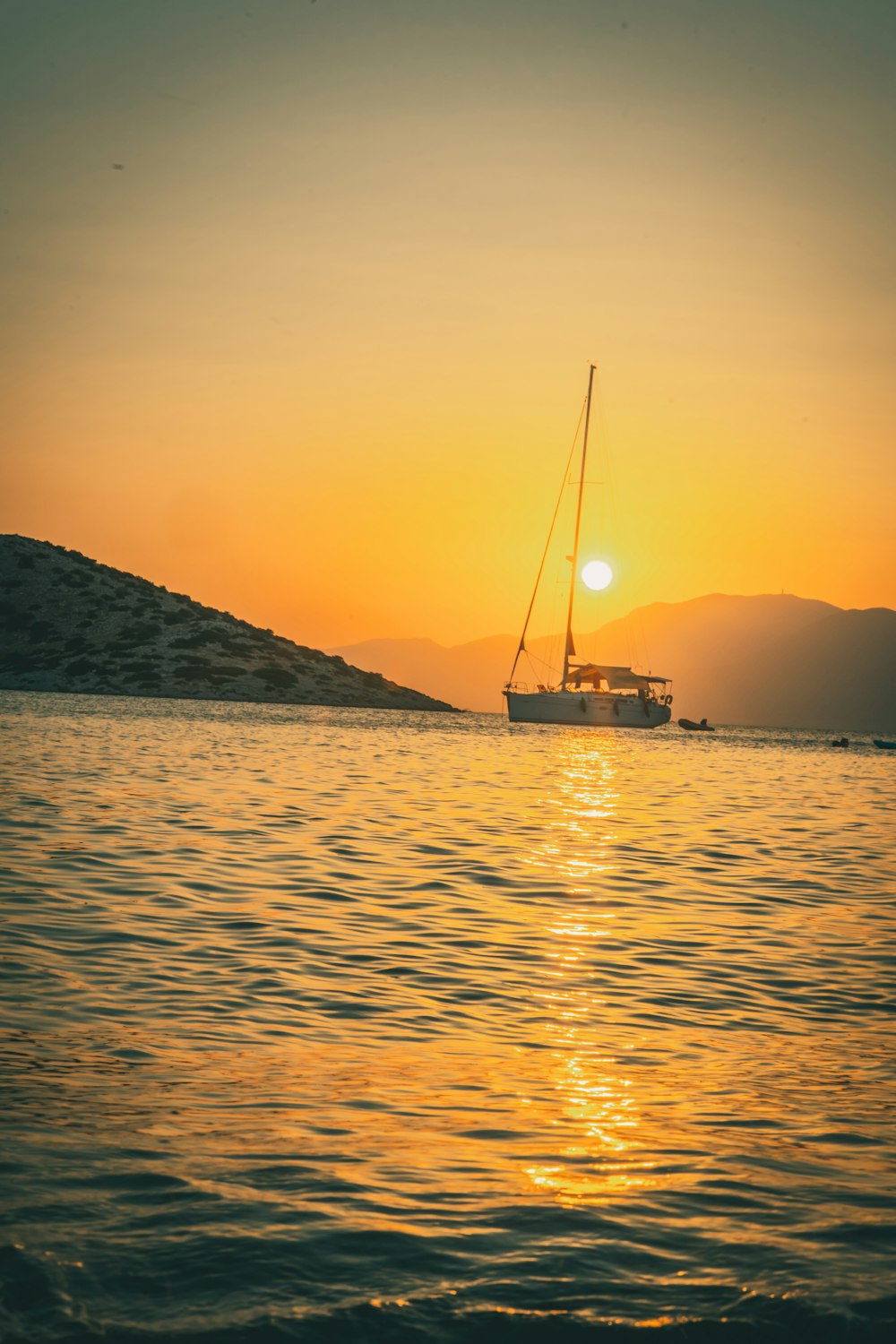 silhouette of boat on sea during sunset