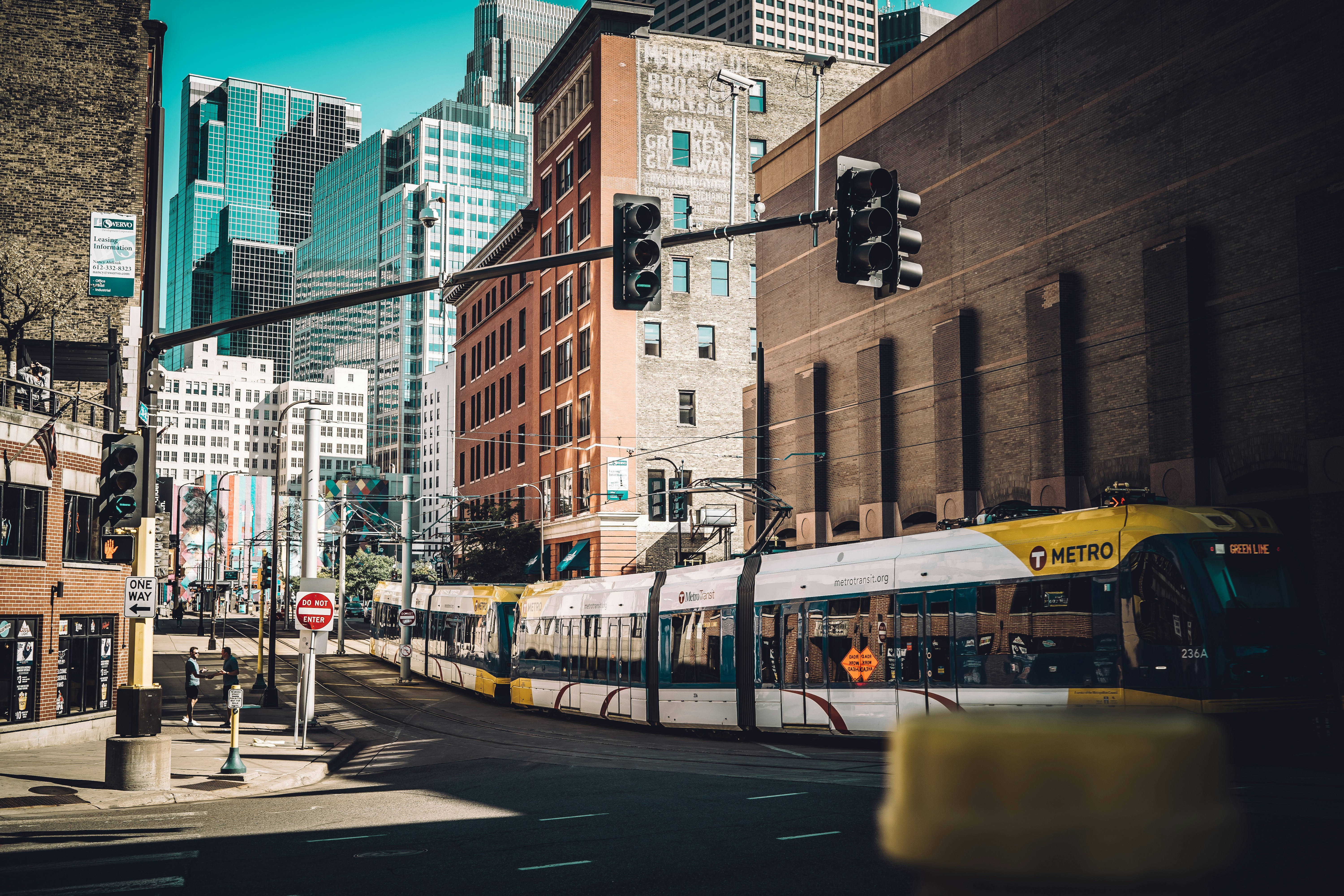 white and yellow train on the city during daytime