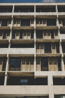 A striking brutalist building facade with bold geometric shapes rendered in cast concrete.