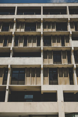 Exterior brutalist style building with geometric lines and concrete facade.