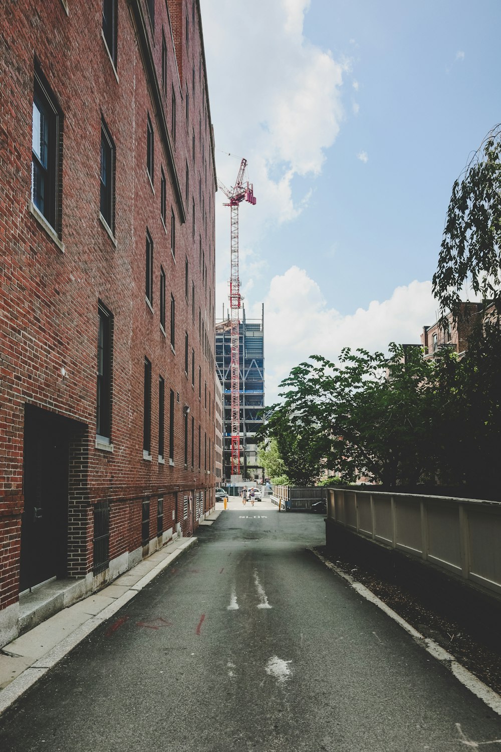 brown brick building beside road during daytime