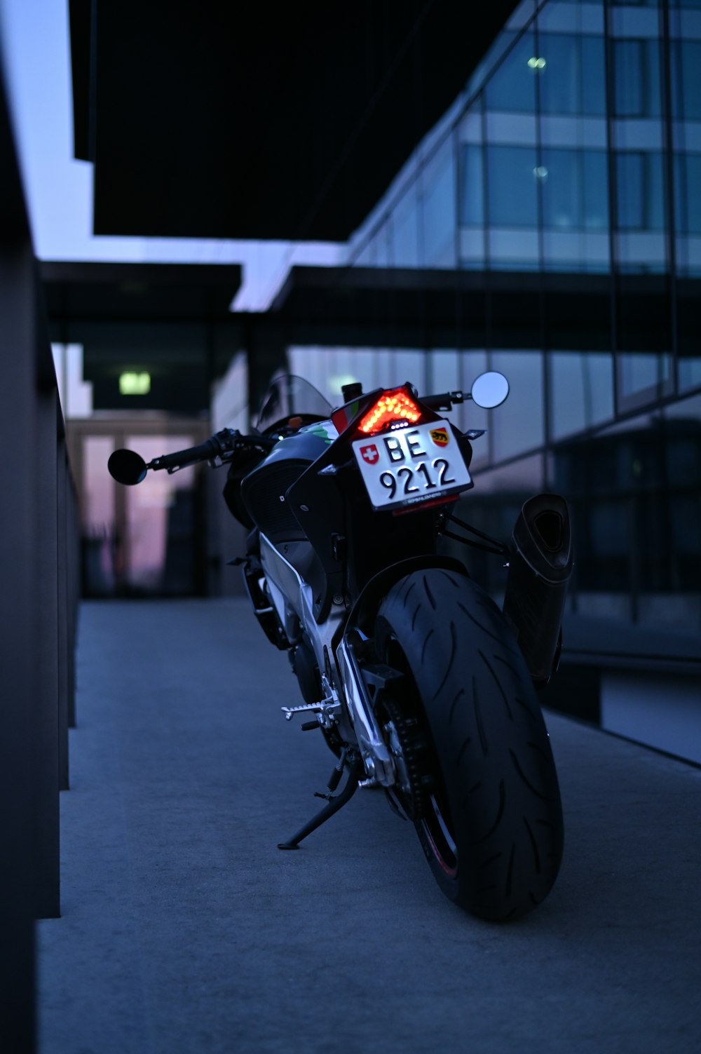 black motorcycle parked on gray pavement