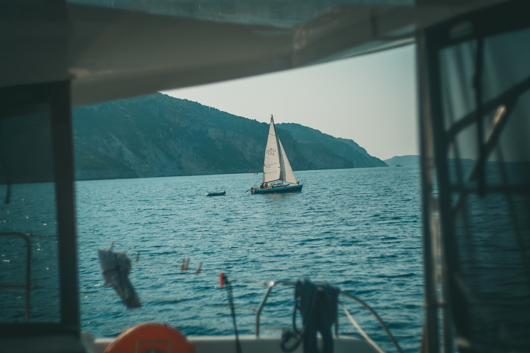 white sail boat on sea during daytime