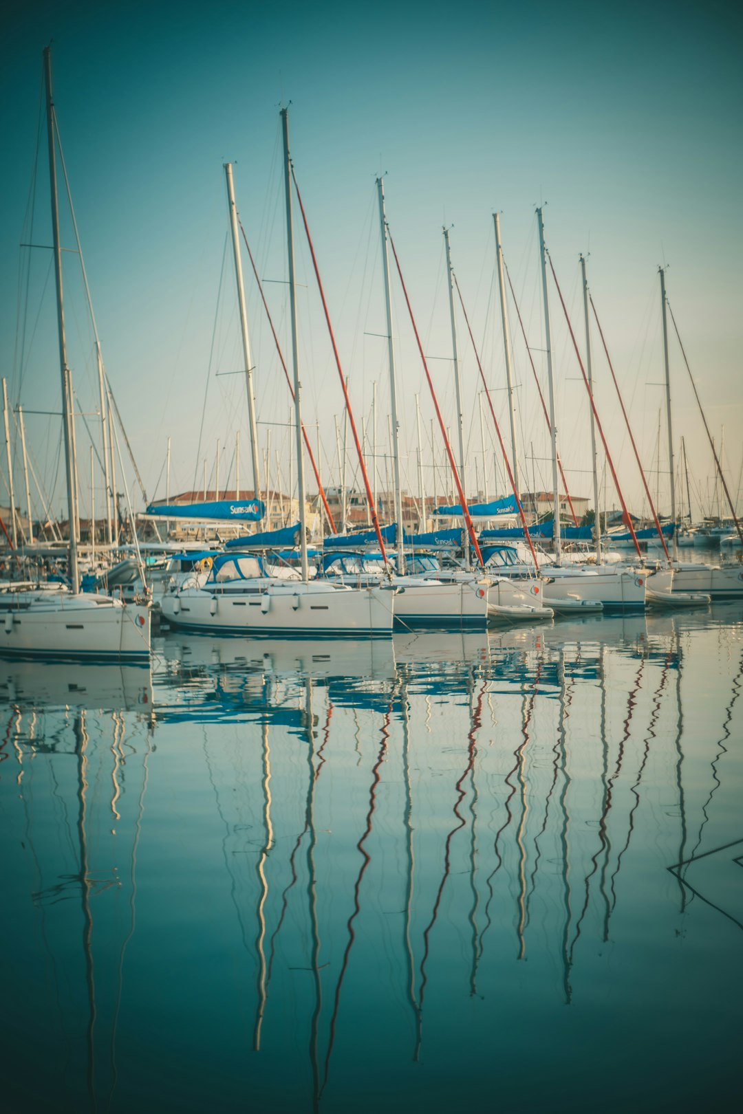 white and blue boats on body of water during daytime