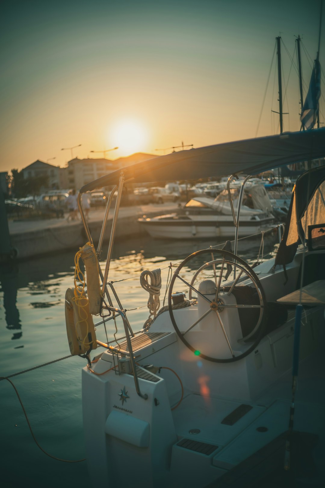 white and black boat on water during sunset