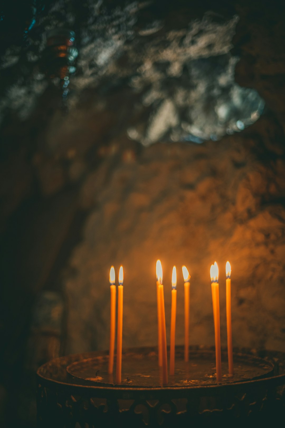 white and orange candles on brown sand