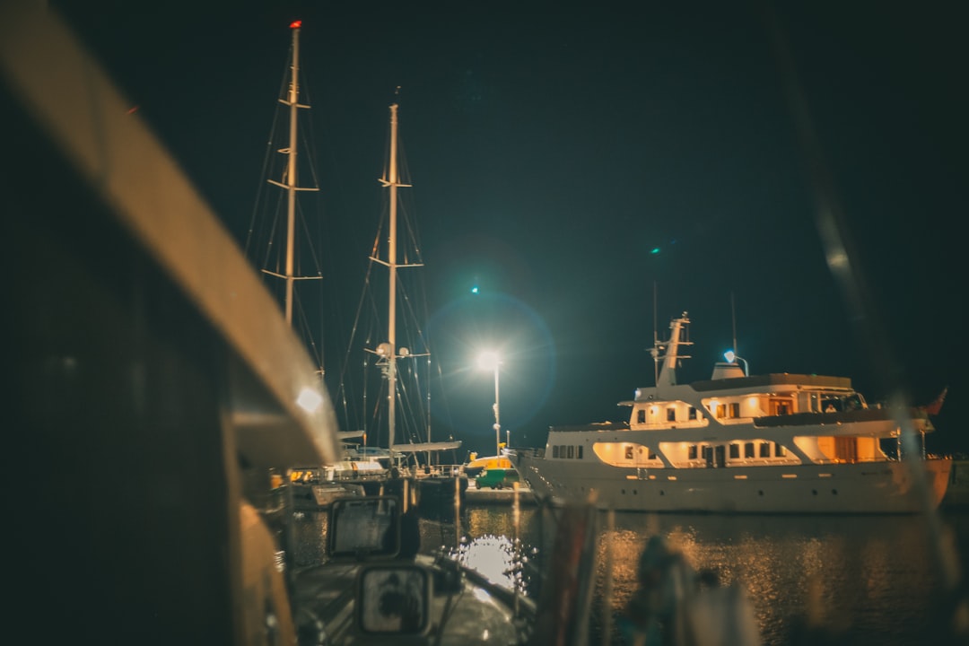 white and black ship on dock during night time