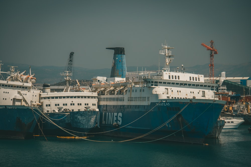 white and blue ship on sea during daytime