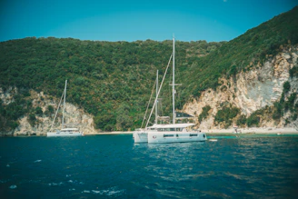 white boat on blue sea during daytime