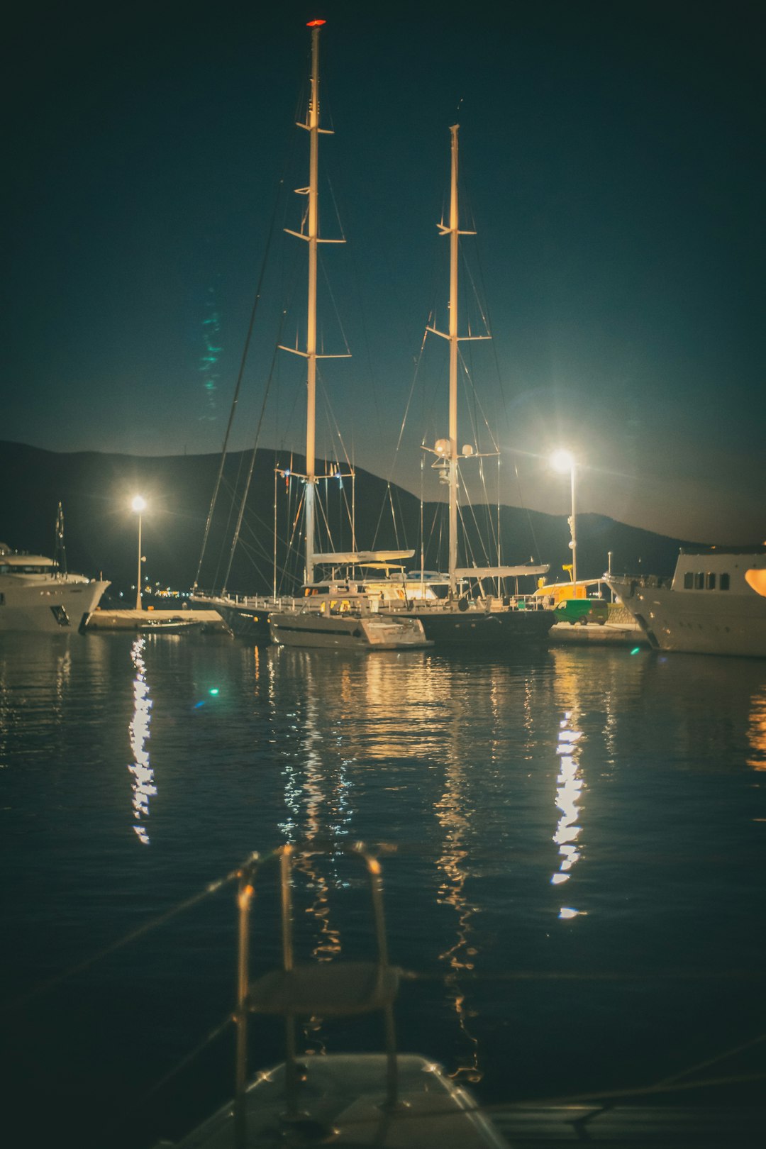 white and blue boat on dock during night time