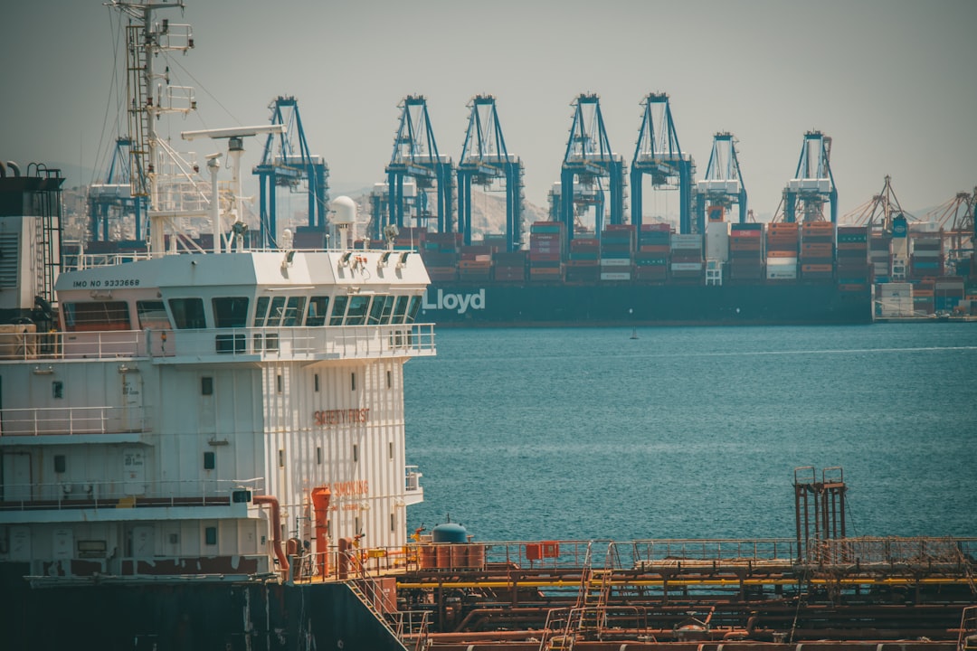 white and red cargo ship on sea during daytime