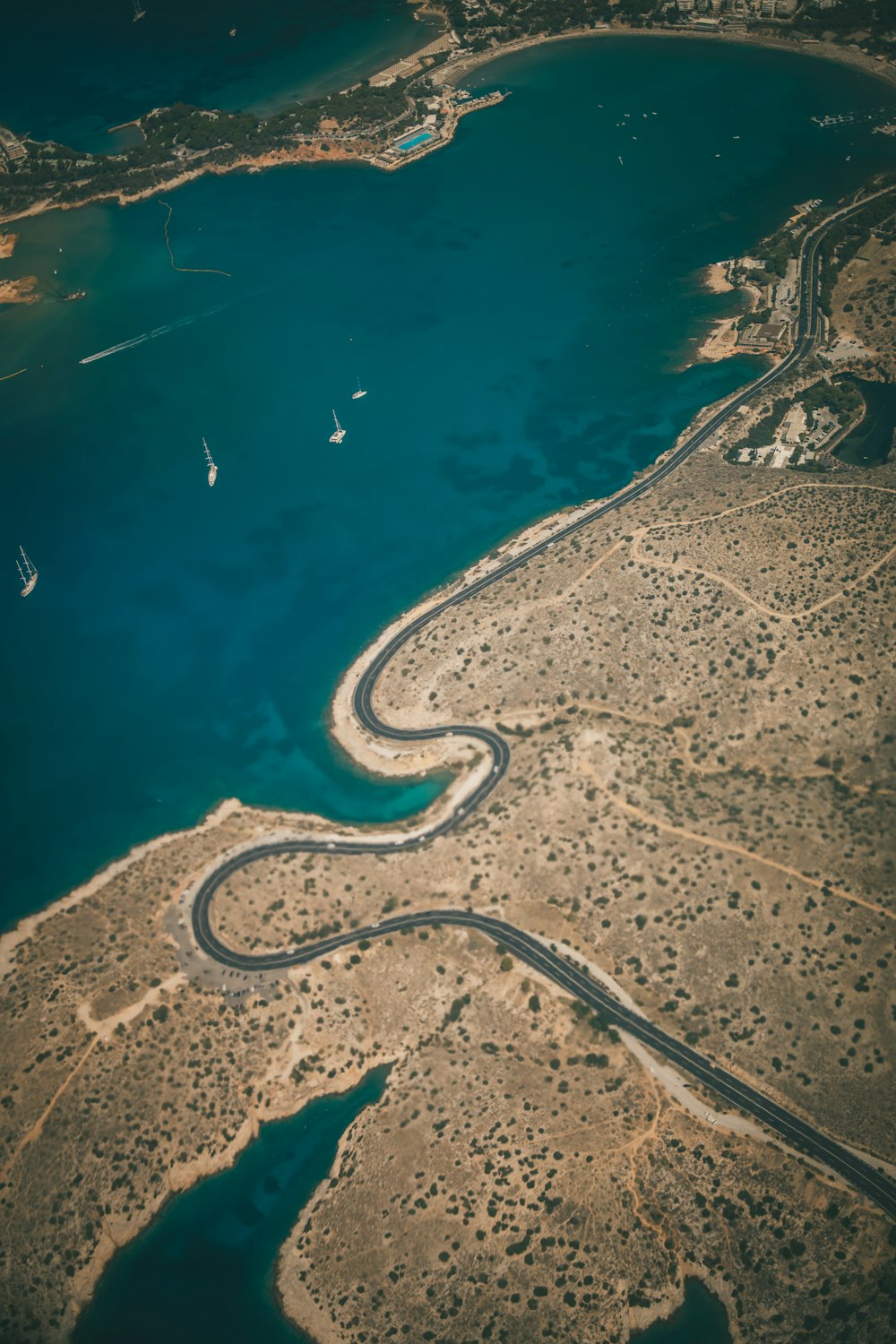 aerial view of road beside river during daytime