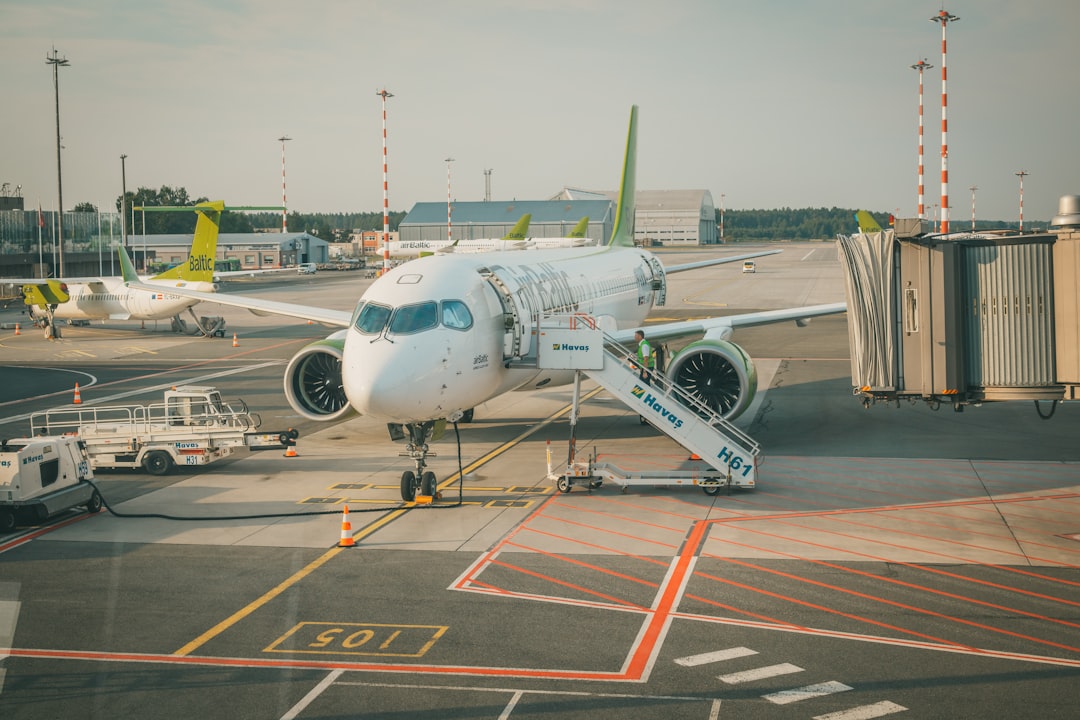 white airplane on airport during daytime