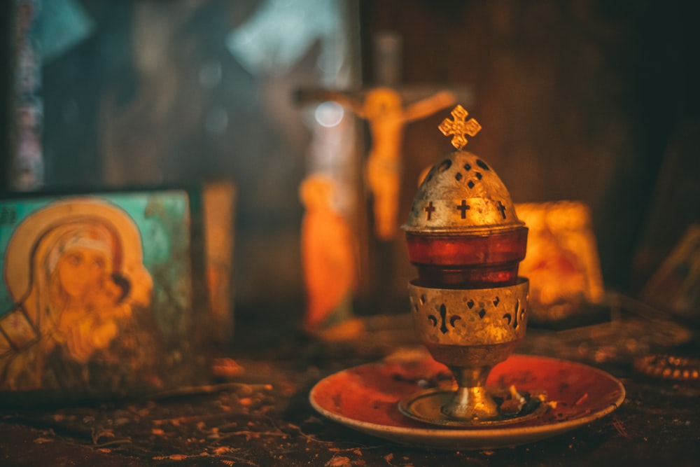 gold and brown steel bell on brown wooden table