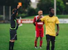 man in black long sleeve shirt holding yellow plastic cup