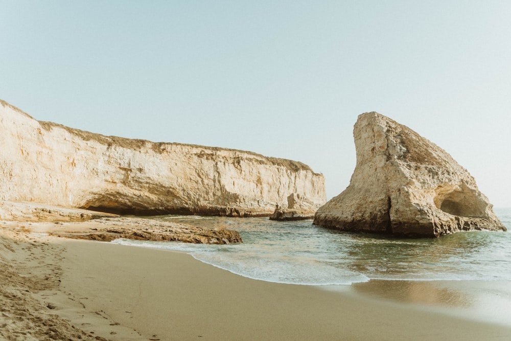 brown rock formation on sea shore during daytime