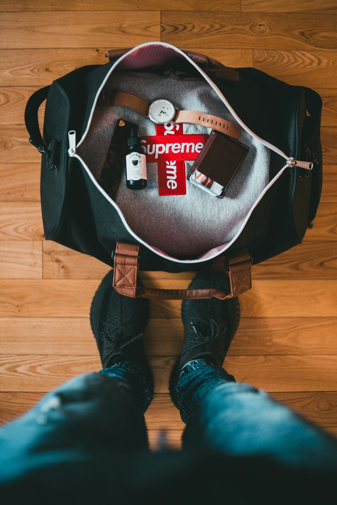 black and gray backpack on brown wooden floor