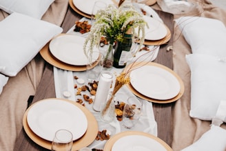 A beautifully arranged wedding table set for an outdoor ceremony.