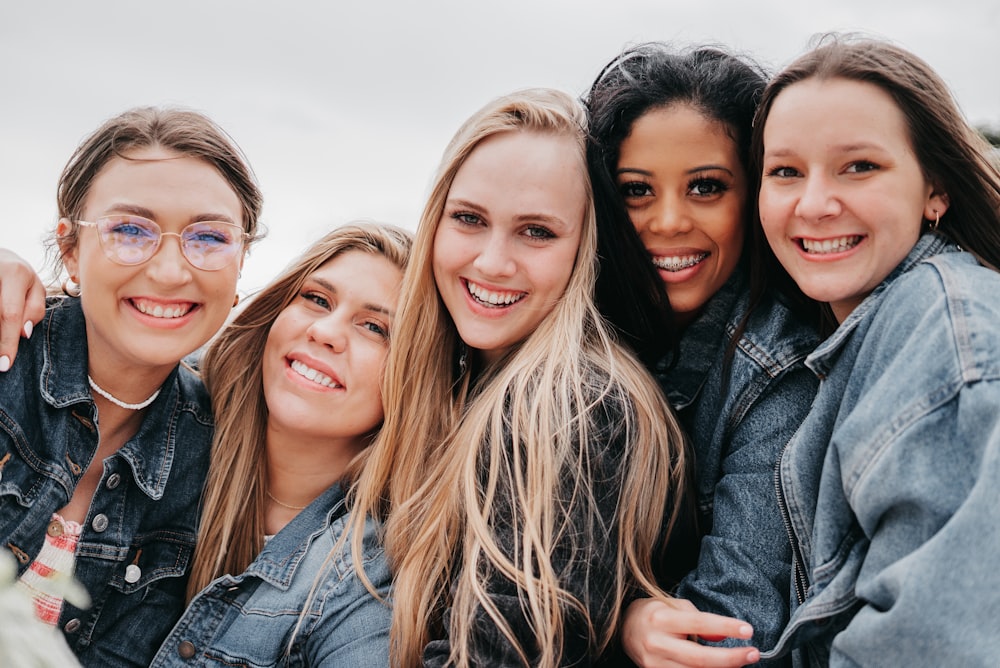 3 women and man smiling