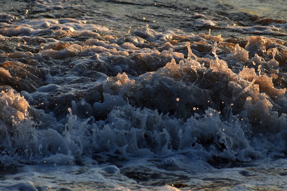 water waves on shore during daytime