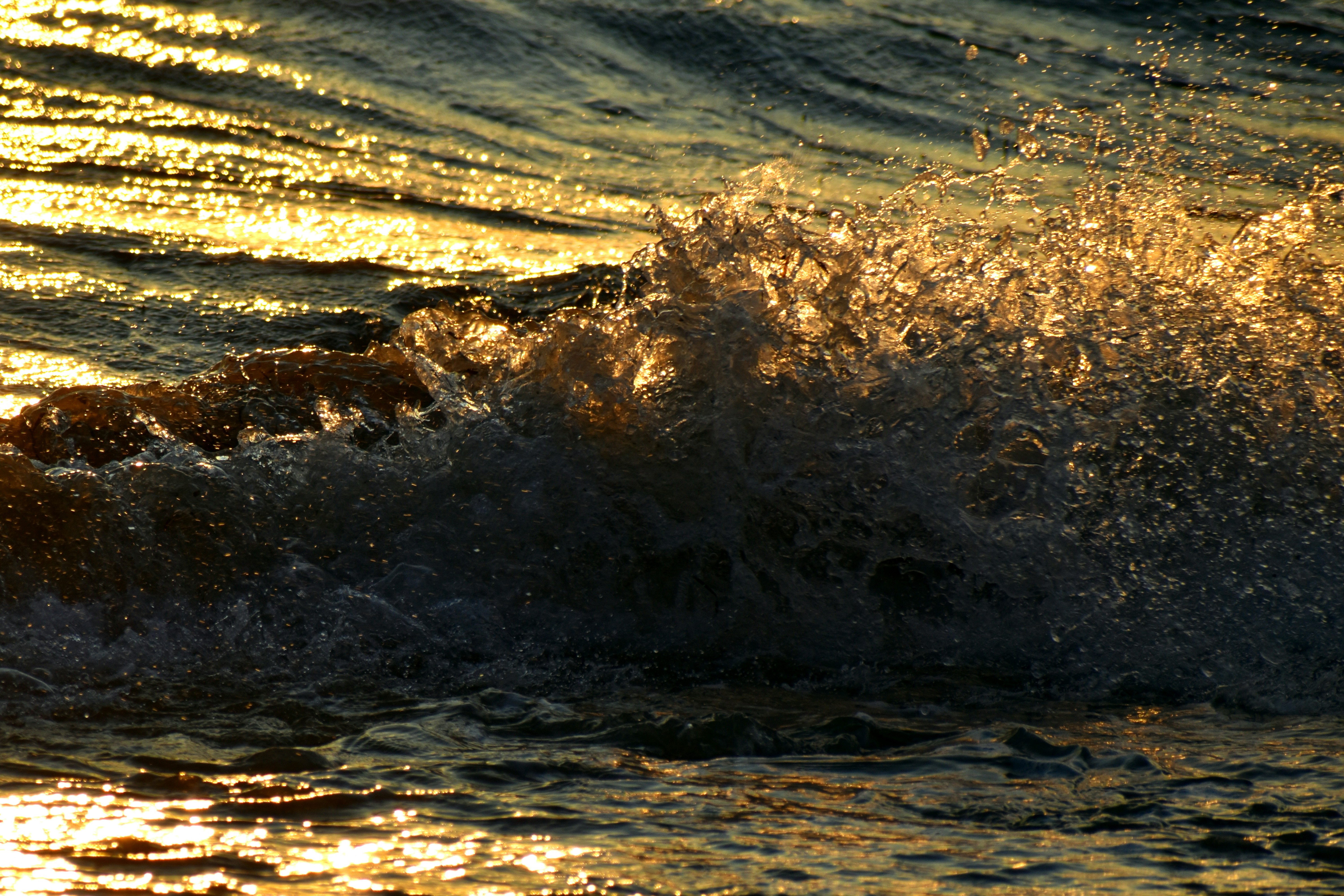 water waves on brown sand during daytime