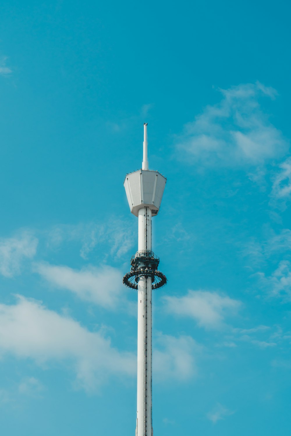 white and black street lamp under blue sky