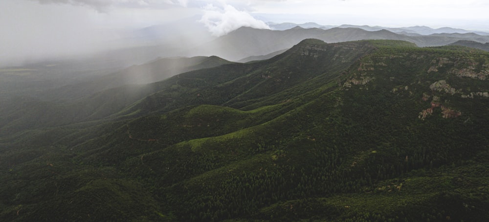 green mountains under white clouds during daytime