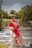 woman in red and white dress standing on snow covered ground during daytime