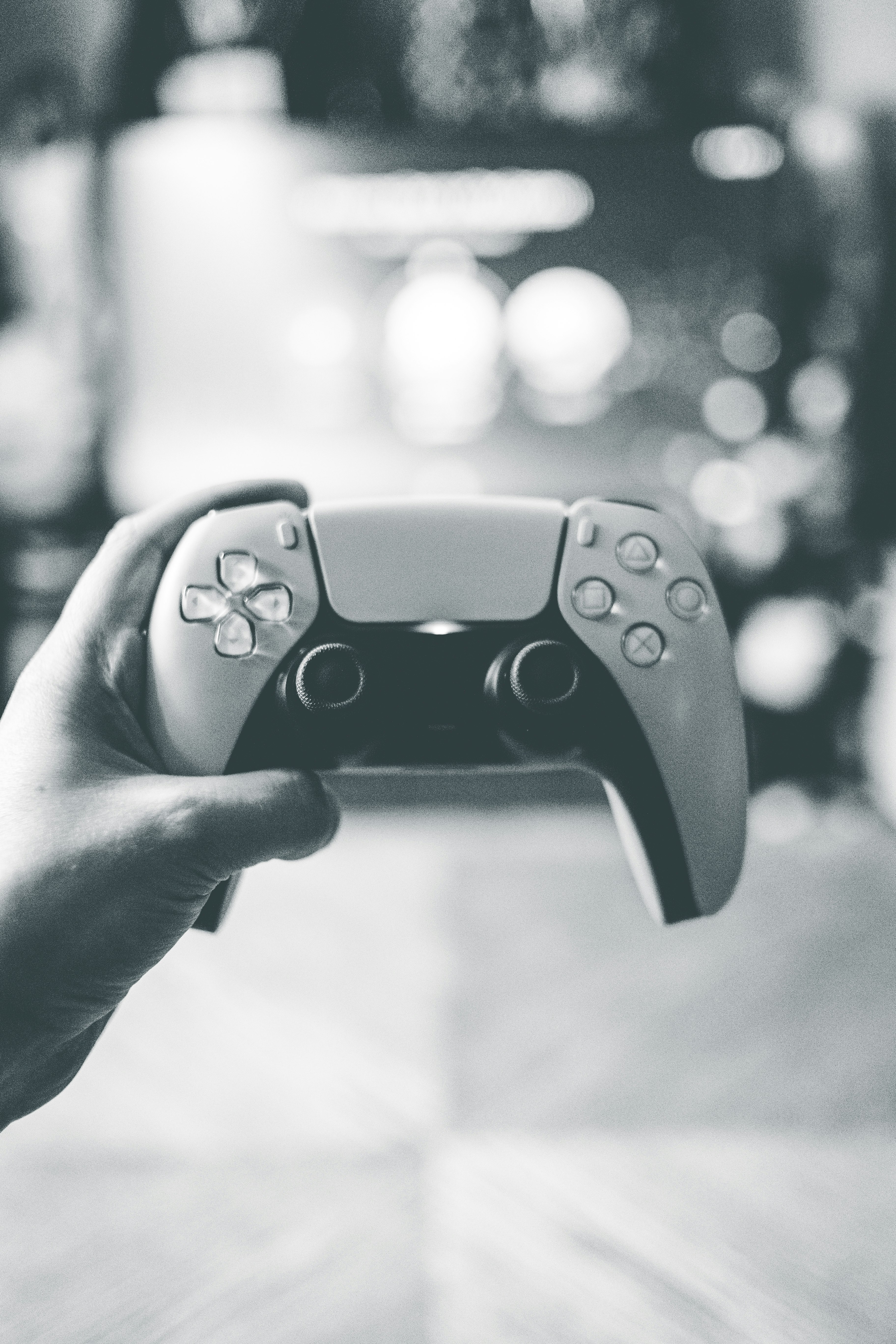 person holding black game controller