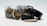 A collection of cannabis-related items, including a glass jar filled with cannabis buds, a metal grinder with its lid off, and a rolled joint laying in front. The scene features earthy tones and metallic highlights.