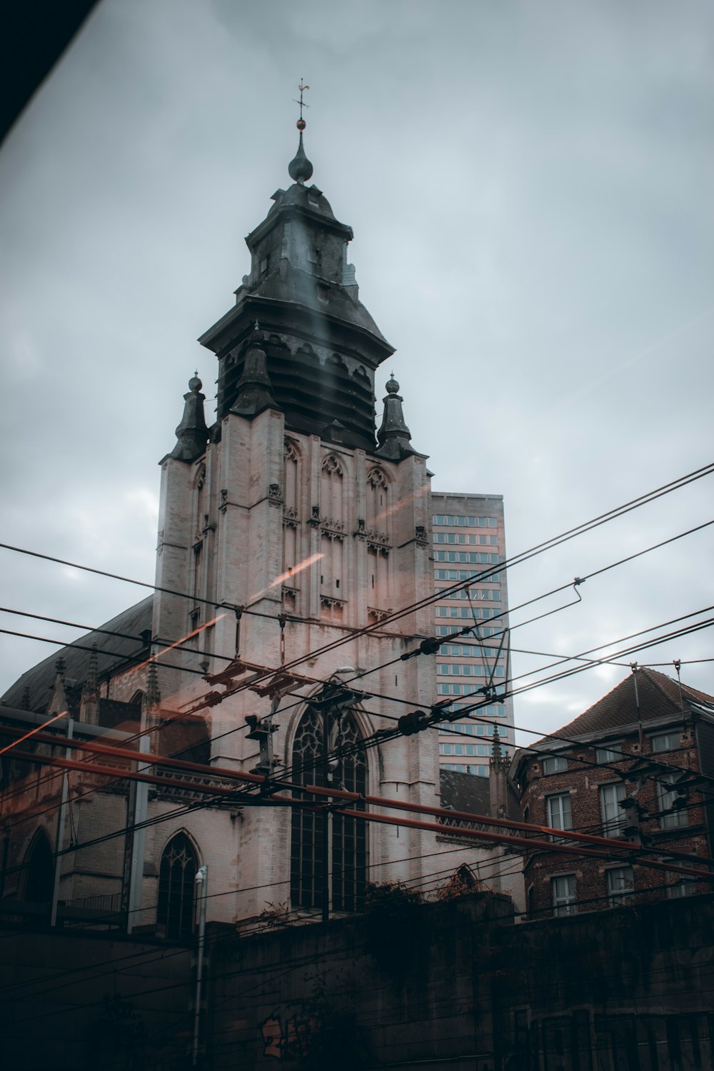 brown concrete building under white clouds during daytime