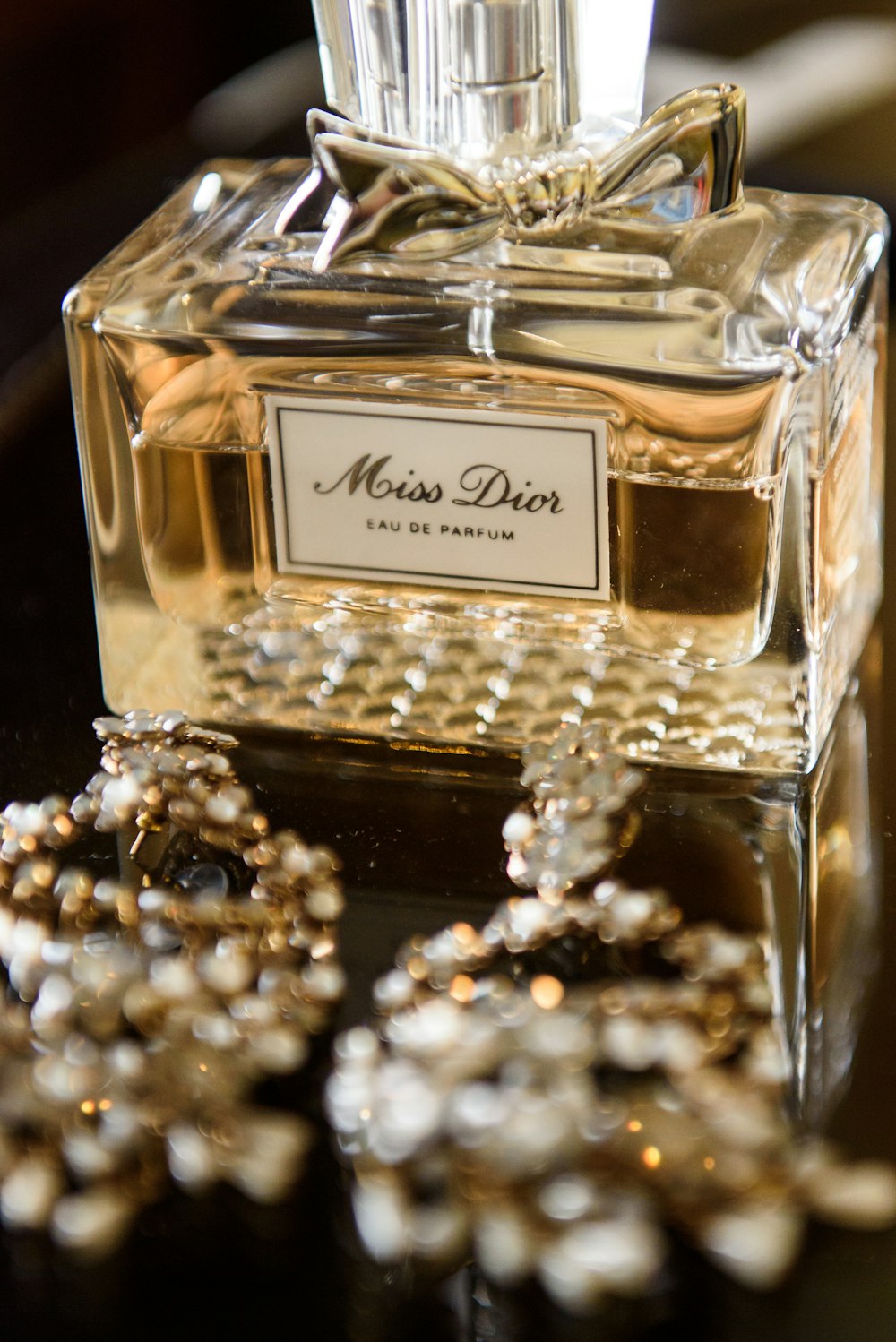 clear glass perfume bottle on brown wooden table