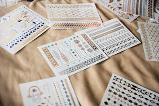 white and black playing cards on brown textile