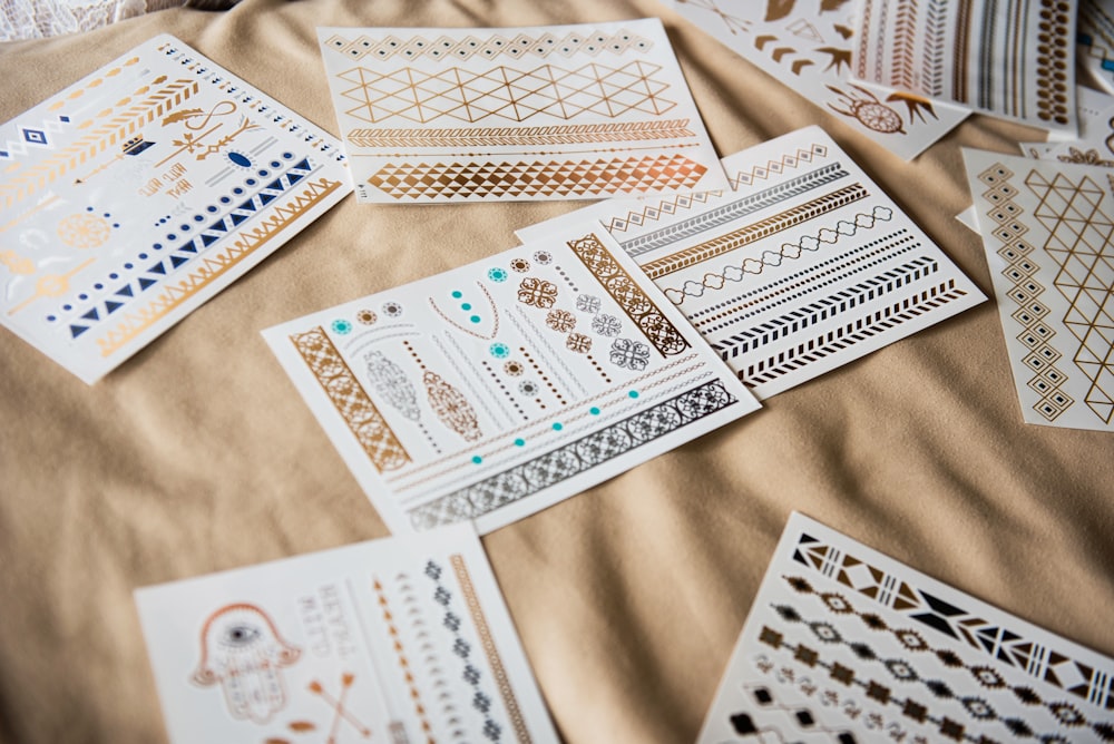 white and black playing cards on brown textile