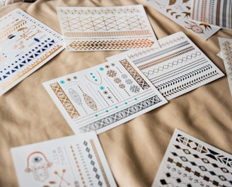 white and black playing cards on brown textile