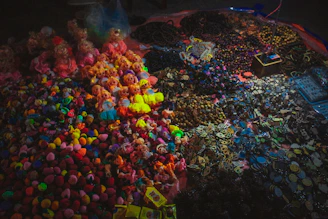 A cozy workspace with colorful crochet threads, handmade amigurumi dolls, and delicate beaded necklaces arranged neatly.