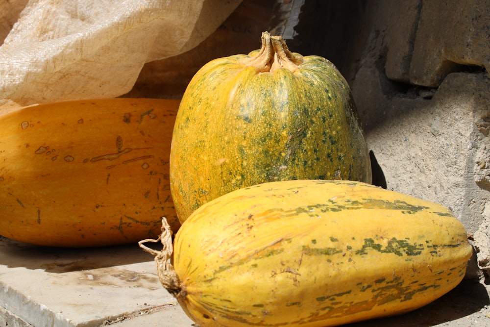 yellow and green squash on gray concrete floor